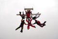 Group of parachutists jump together from an airplane under the cloudy sky. Royalty Free Stock Photo