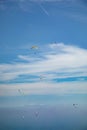 Group of parachutists on paragliders in flight with background in blue sky Royalty Free Stock Photo