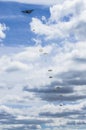 A group of paratroopers jumping from the plane one after another