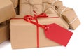 Several brown paper packages, red gift tag, copy space, isolated on white Royalty Free Stock Photo