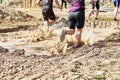 Group of participants in an obstacle course race running across a pool of water. Spartan race. Concept of hardness