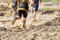 Group of participants in an obstacle course race running across a pool of water. Spartan race