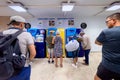 Group of passengers waiting in front of vending machines to get their metro passes in Lisbon