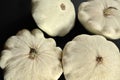Group of pattypan squashes on dark wood board, closeup detail Royalty Free Stock Photo