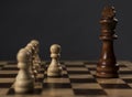 Group of pawns before king on chess board, concept Royalty Free Stock Photo