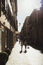 Group of pedestrians walking the streets of Rome, Italy on a sunny day