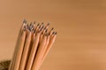 Group of pencils standing on brown background Royalty Free Stock Photo