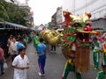 A group of people accompany a large dragon in a Festival of the Clans of the Chinese community of Bangkok