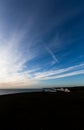 Group of people admire sunset at cliffs edge in East Sussex England