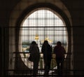 Group of people admiring looking through a fenced window to the St Sophia's cathedral in Kyiv