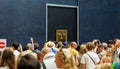 Group of people admiring the Mona Lisa painting in the louvre museum