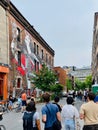 Group of people admiring a vibrant artwork in the Mural Festival D'Art Urbain of 2023 in Montreal