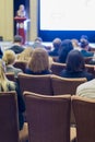 Group of People Attending Conference and Listening to the Host Speaker On Stage.