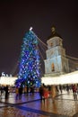 The group of people and the Bell Tower of Saint Sofias Cathedral and New Year Tree