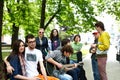 Group of people on bench in park. Royalty Free Stock Photo