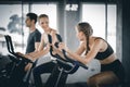 Group of people biking in the gym, exercising legs doing cardio workout cycling bikes. Royalty Free Stock Photo