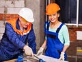 Group people builder cutting ceramic tile.