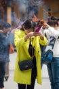 Group of people burning incense and praying in a temple in China Royalty Free Stock Photo