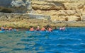 Group of people on canoeing in the ocean with mountains. Kayaks. Royalty Free Stock Photo