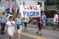 Group of people carry sign to close Pilgrim Nuclear Power Station in Wellfleet, MA