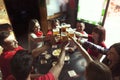 Group of people celebrating in a pub drinking beer