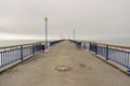 Group of people in Christchurch Pier at New Brighton Beach on a gloomy winters day in New Zealand Royalty Free Stock Photo