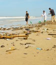 people cleaning ocean beach plastic
