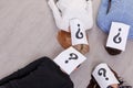 A group of people with closed faces with a question mark on the floor Royalty Free Stock Photo