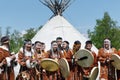 Group of people in clothing aborigine of Kamchatka stand on background at yaranga