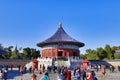Group of people clustered around the entrance of the Temple of Heaven. Beijing, China.