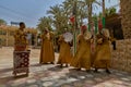 a group of people in colorful dress playing drum instruments outside Royalty Free Stock Photo