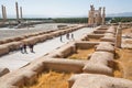 Group of people come in area of destroyed city Persepolis