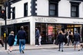 Group of People Crossing The Main Road Next To A High Street Pret A Manger Coffee Shop