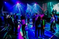 Group of people dancing on a dance floor in dark night club environment