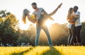 Group of people dancing Kizomba in sunset