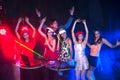 Group of people dancing at night club party and lights background. Royalty Free Stock Photo