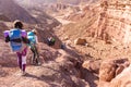 Group people descending walking stone desert trail backpacking travel