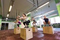 Group of people doing box jumps exercise in gym Royalty Free Stock Photo