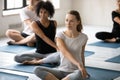 Group of people doing Easy Pose with Twist yoga indoors Royalty Free Stock Photo