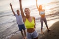 Group of people doing exercises on the beach. Fitness, training, sport and people concept Royalty Free Stock Photo