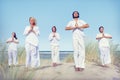 Group of People Doing Yoga on Beach