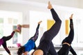 Group of people doing yoga training in yoga class in the indoor gymnasium to relax and get healthy health. Sport and recreation Royalty Free Stock Photo