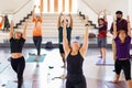 Group of people doing yoga training in yoga class in the indoor gymnasium to relax and get healthy health. Sport and recreation Royalty Free Stock Photo