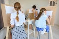 Group of people draw still life on easels