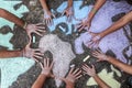 A group of people drawing with colored chalks on the floor with his hands in the street a map of the world Royalty Free Stock Photo