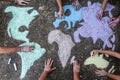 A group of people drawing with colored chalks on the floor with his hands in the street a map of the world Royalty Free Stock Photo
