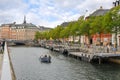 A group of people enjoy a canal cruise near Van Stranden and the historic center on an overcast Autumn day in Copenhagen Denmark.