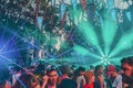 Group of people enjoying the Noisily Festival under a canopy of lights in vibrant colors.