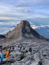 Group of people enjoying a picturesque view atop the Mount Kinabalu peak in Sabah, Malaysia