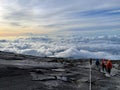 Group of people enjoying a picturesque view atop the Mount Kinabalu peak in Sabah, Malaysia